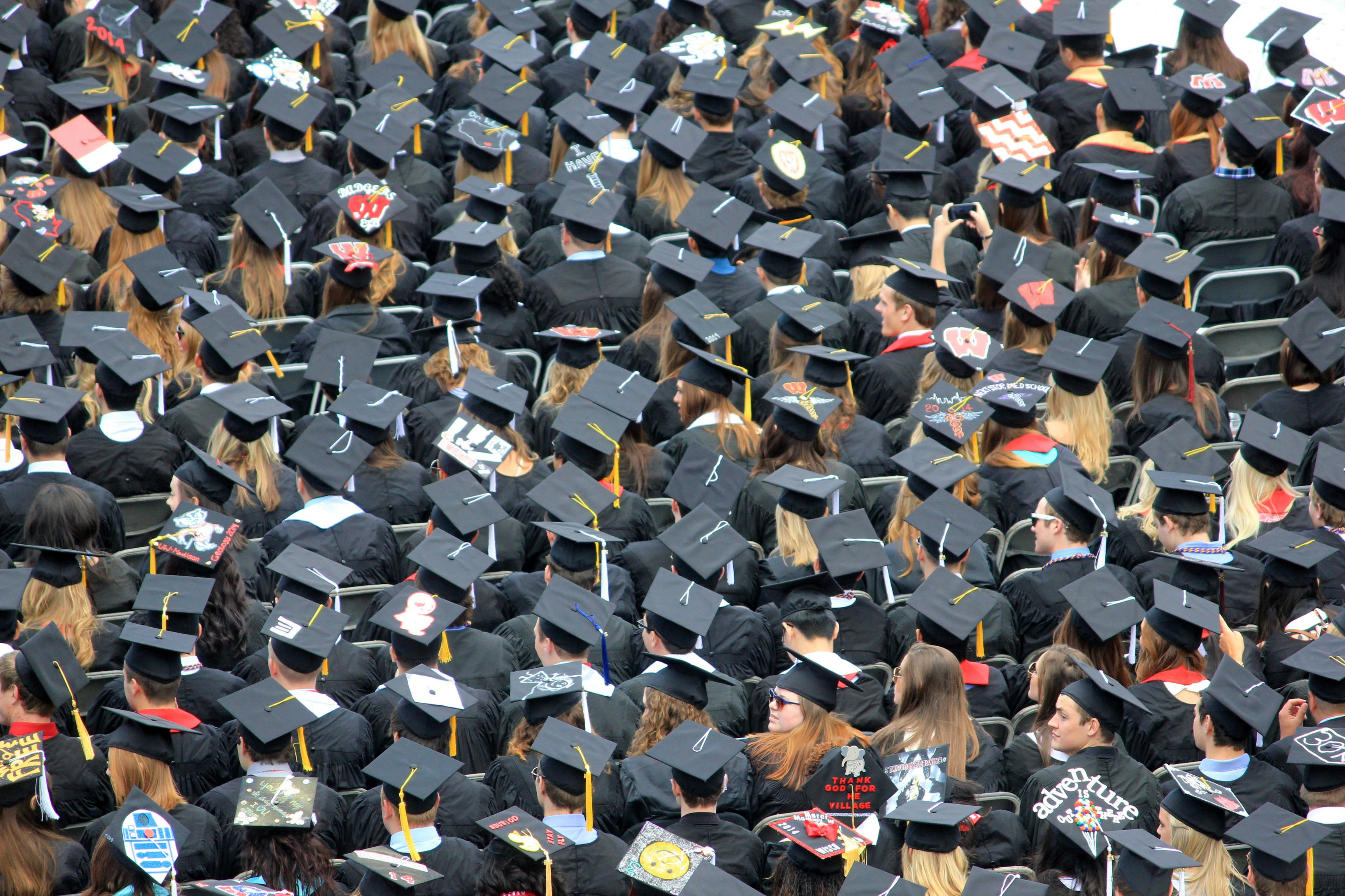 A crowd of students wearing their caps and gowns